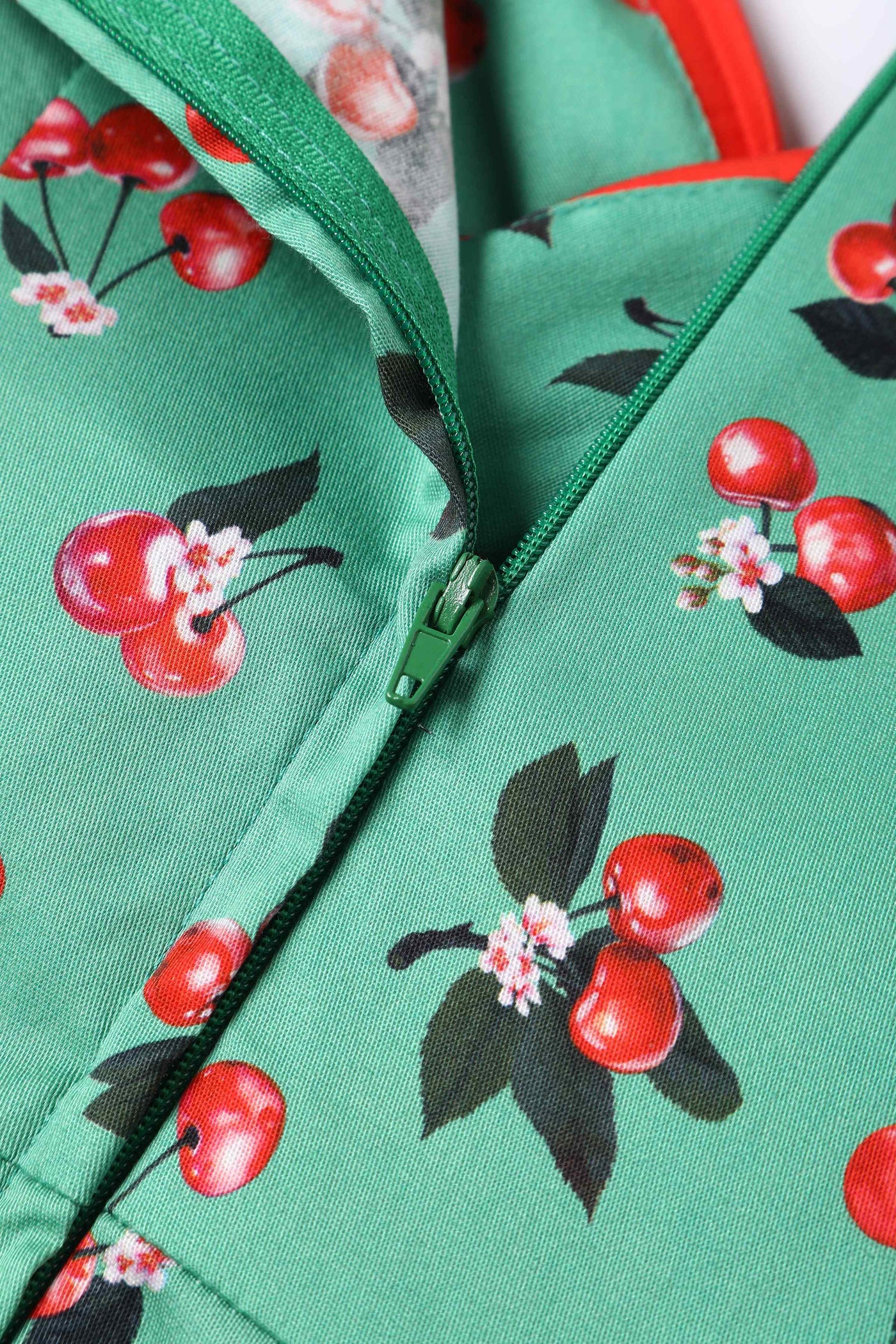 Close up View of Cherry Pleated Bust Dress in Emerald Green