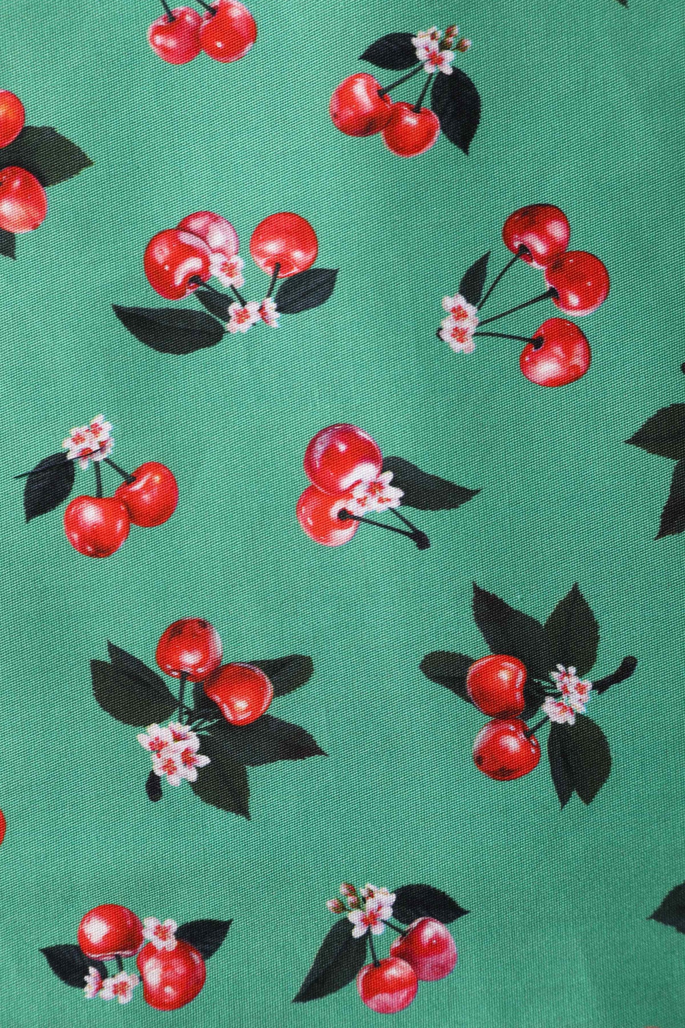 Close up View of Cherry Pleated Bust Dress in Emerald Green