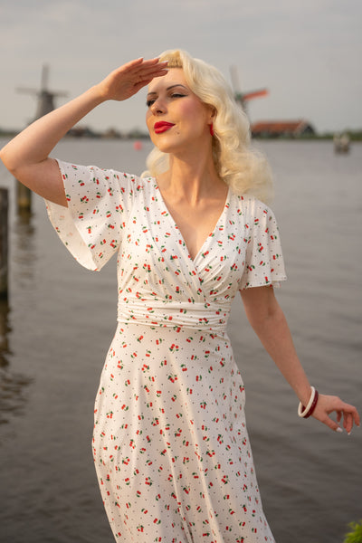 A model wearing a Cherry White Crossover Bust Dress