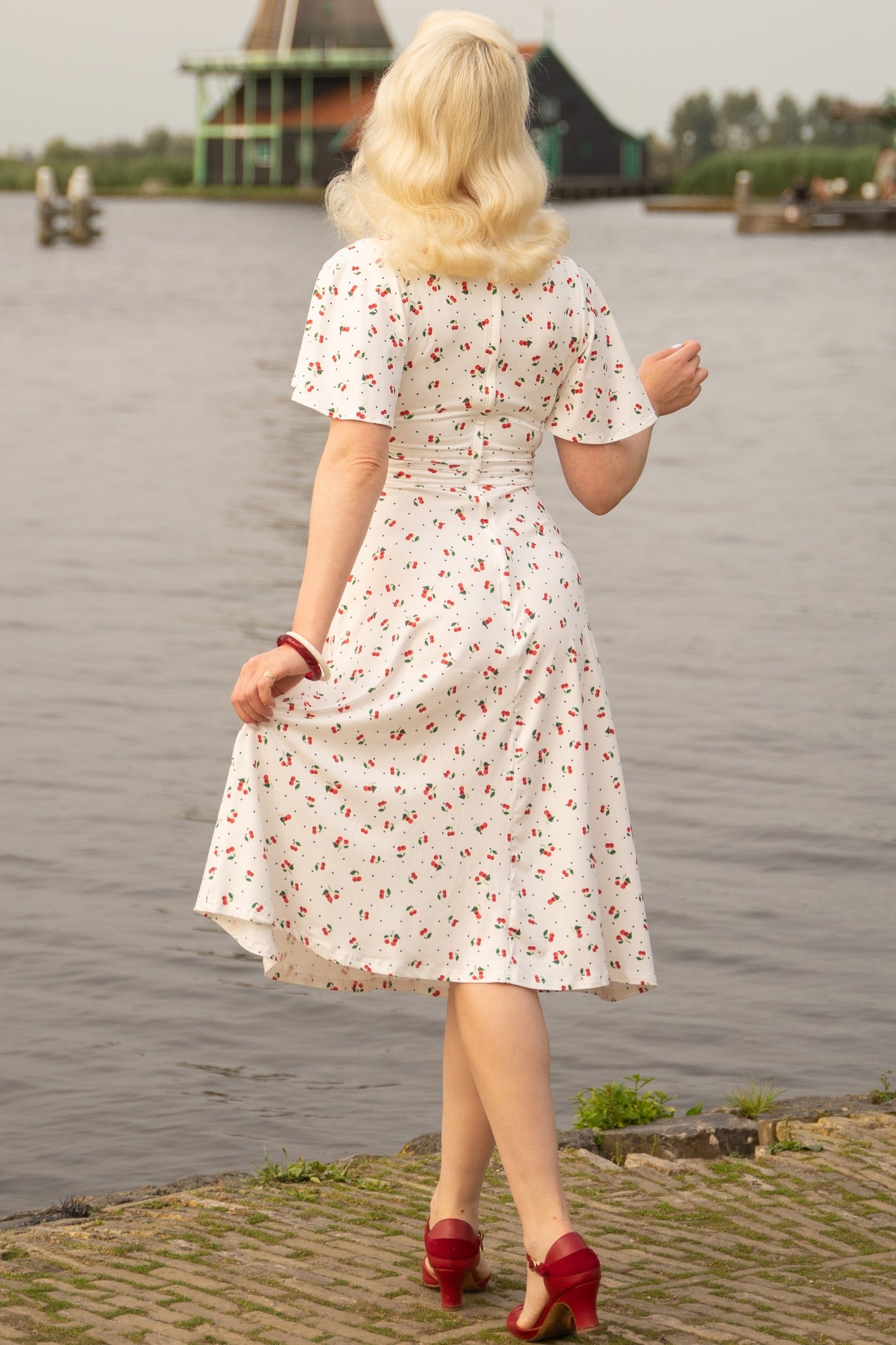 A model wearing a Cherry White Crossover Bust Dress
