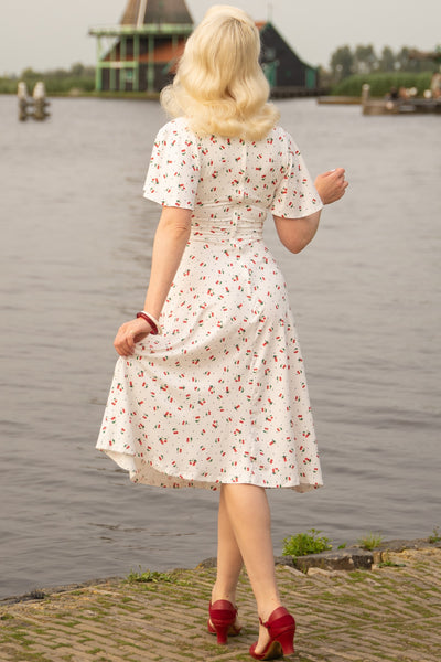 A model wearing a Cherry White Crossover Bust Dress
