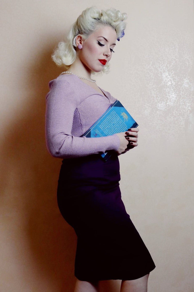 Woman wears our purple skirt, with accessories, side view