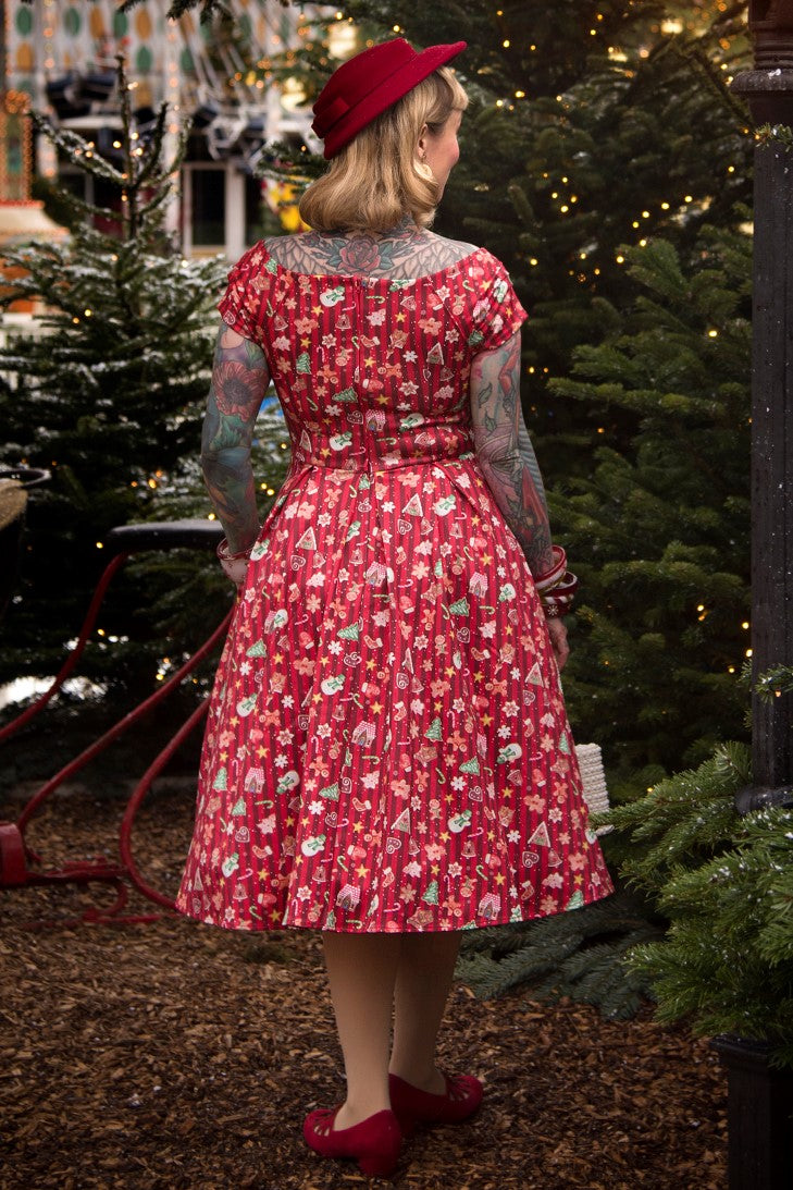 A lady wearing a Lily Christmas Gingerbread Cookie Off Shoulder Dress