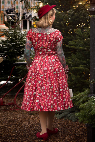 A lady wearing a Lily Christmas Gingerbread Cookie Off Shoulder Dress