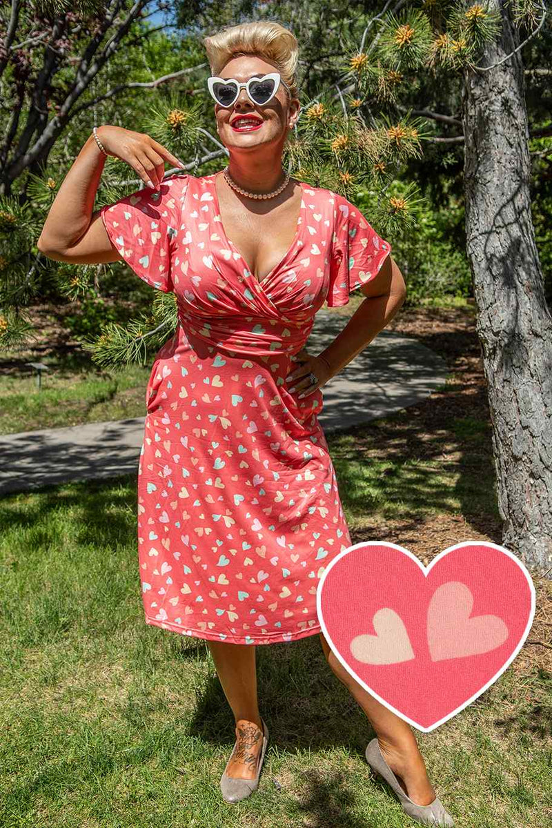 A model wearing a Coral Heart Crossover Bust Tea Dress