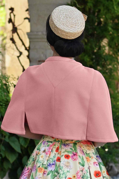 A model wearing a Sabrina Coral Pink Cape Jacket