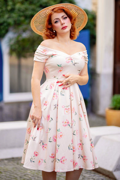 A model wearing a Cream & Pink Peony Off Shoulder Dress