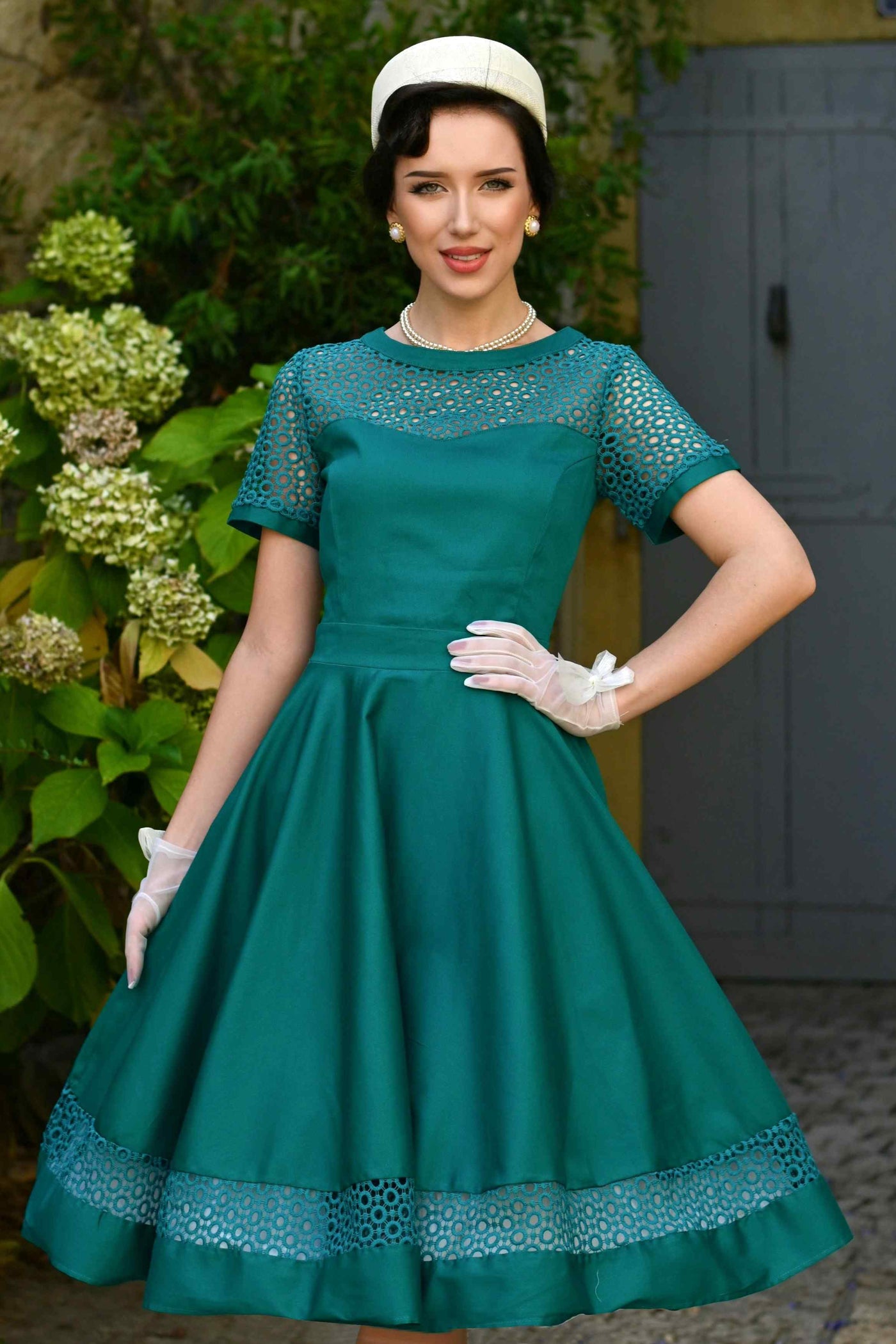 A model wearing a Tess Crochet Lace Formal Dress In Emerald Green