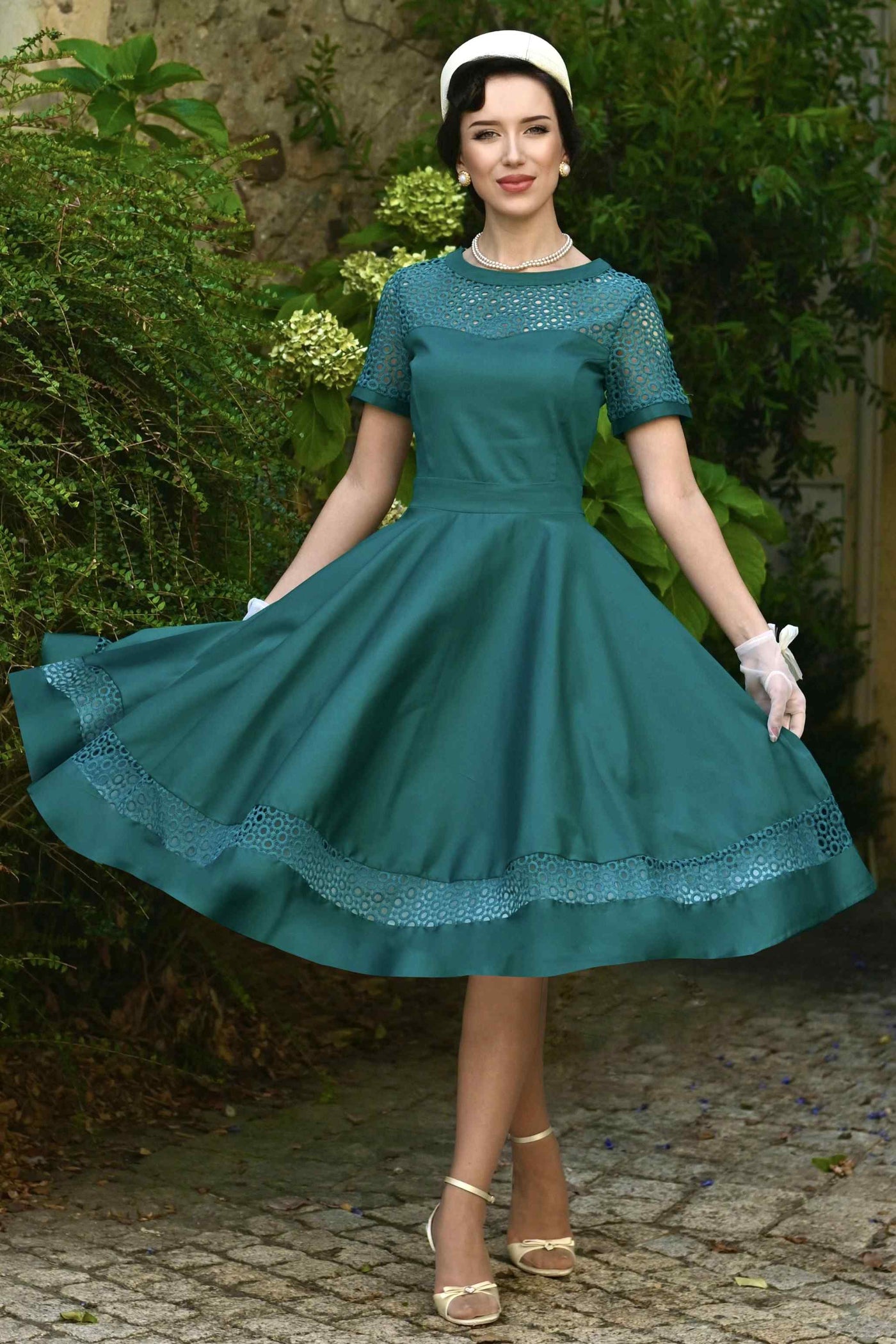 A lovely model wearing a Tess Crochet Lace Formal Dress In Emerald Green