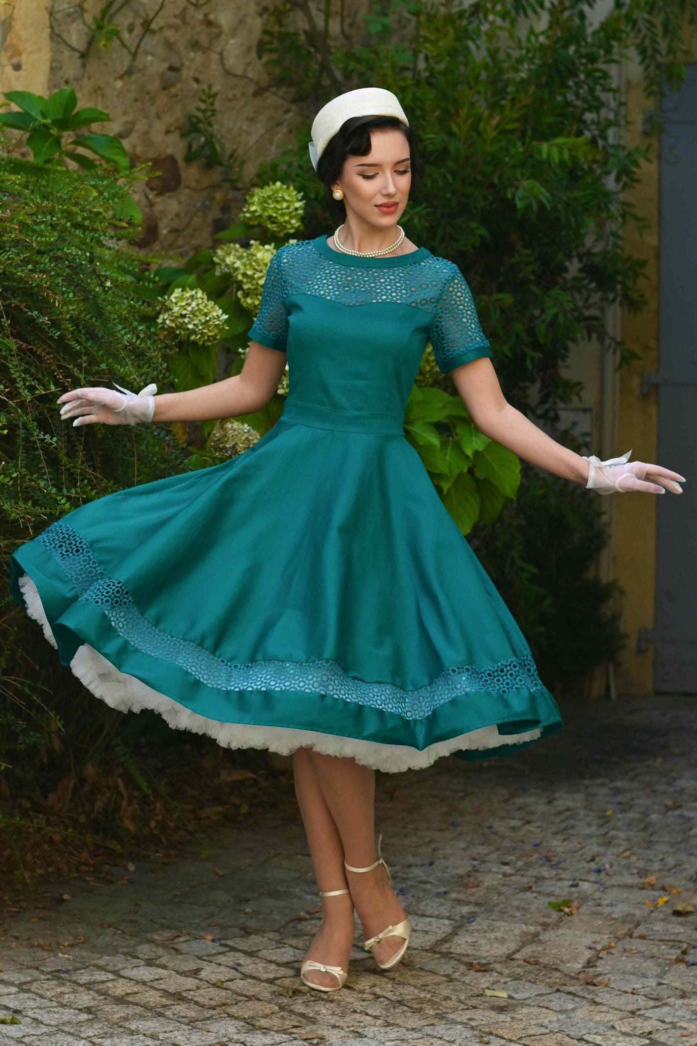 A lady wearing a Tess Crochet Lace Formal Dress In Emerald Green
