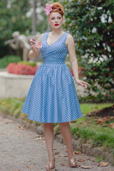 A model wearing Crossover Bust Blue and White Polka Dot Dress