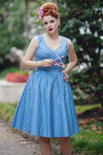 A model wearing Crossover Bust Blue and White Polka Dot Dress