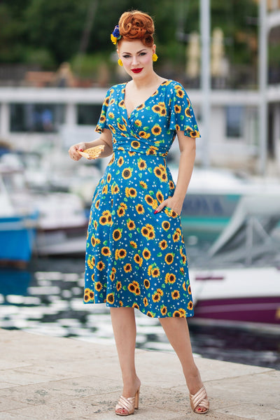 A lady wearing a Crossover Bust Blue Sunflower Dress