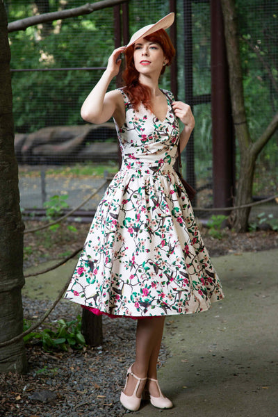 A model wearing a May Crossover Bust Circle Dress In White Bird Print
