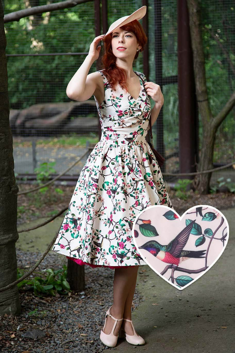 A model wearing a May Crossover Bust Circle Dress In White Bird Print