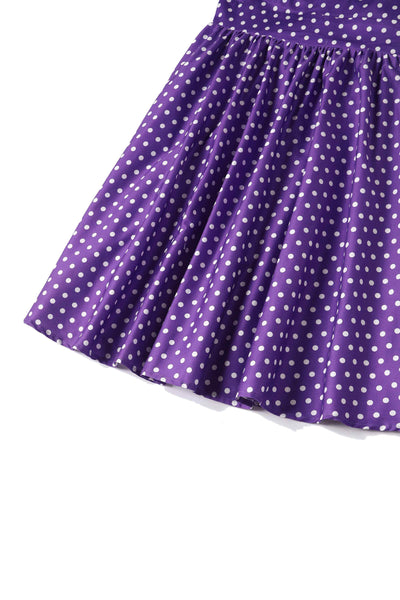 Close up of purple with white polka dots skirt part of dress