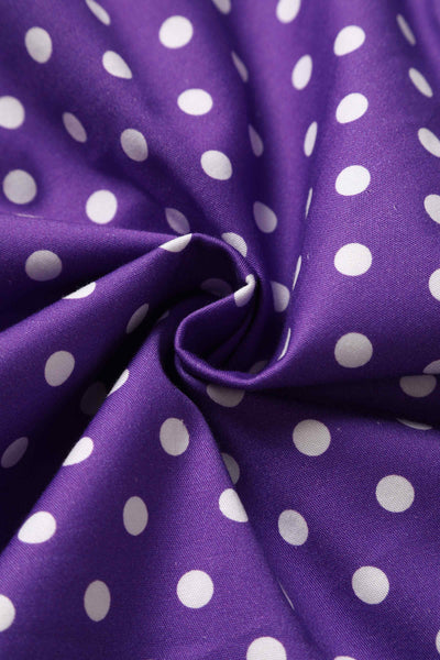 Close up of purple with white polka dots fabric