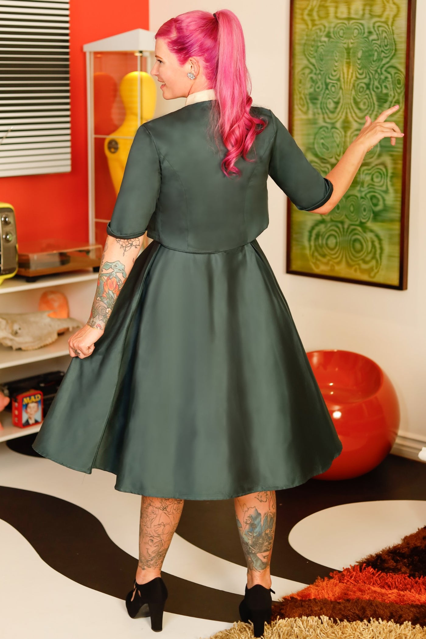A model wearing a Dark green bolero