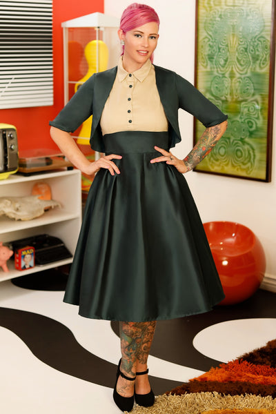 A model wearing a Dark green bolero