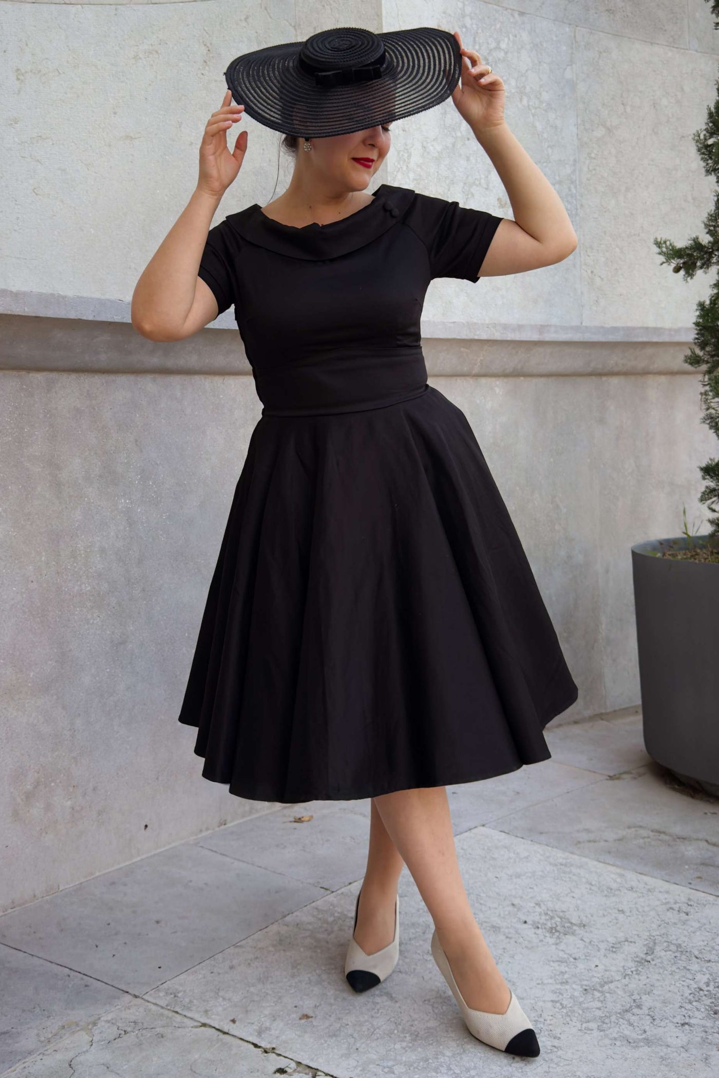 A lady wearing a Darlene Little Black Dress