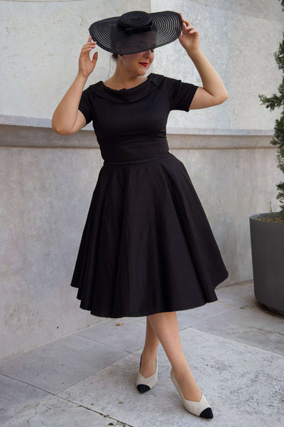 A lady wearing a Darlene Little Black Dress