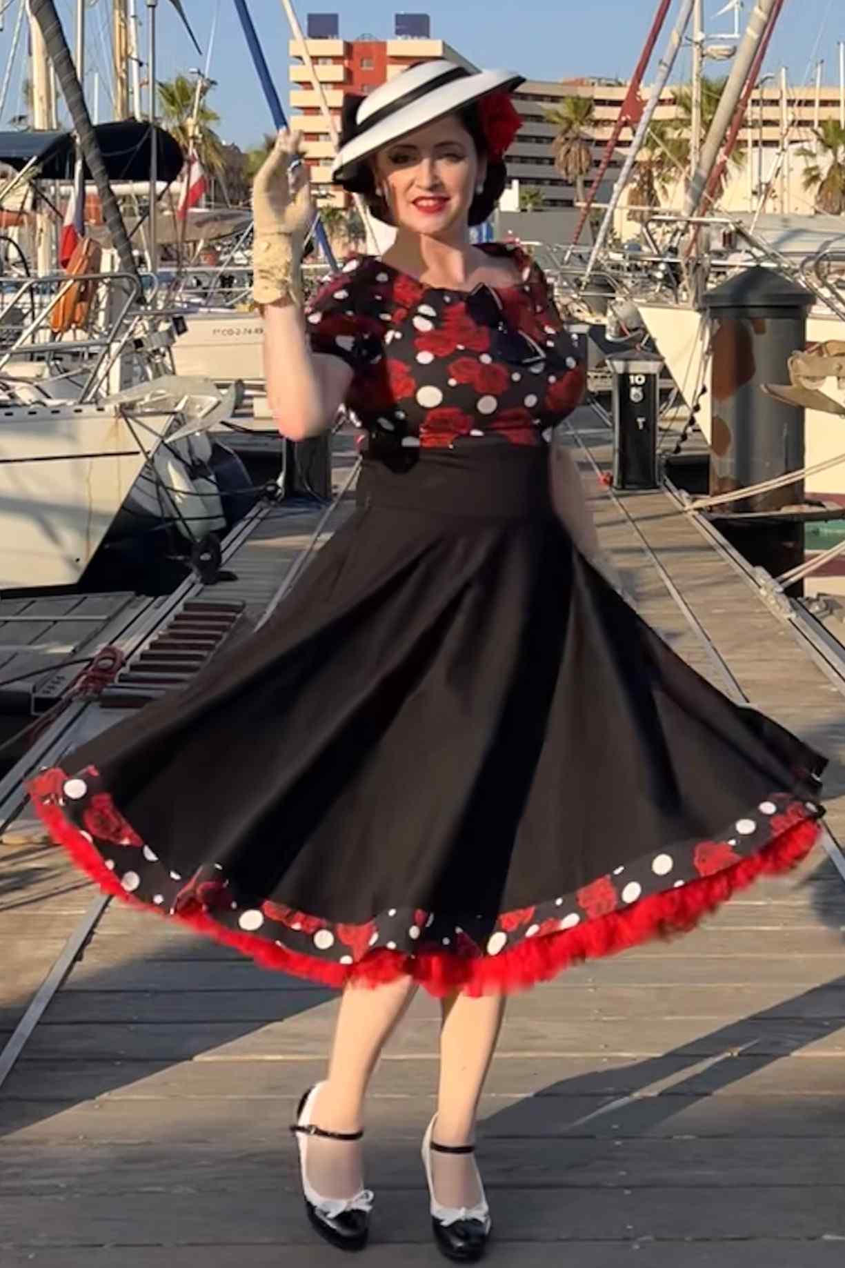 A lady wearing Rockabilly Rose Polka Dot Swing Dress