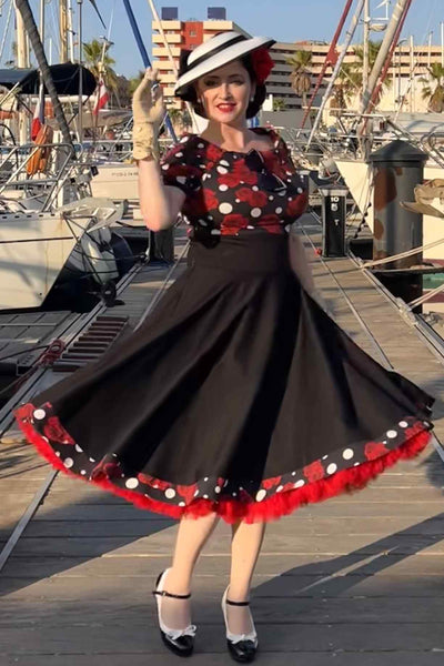 A lady wearing Rockabilly Rose Polka Dot Swing Dress