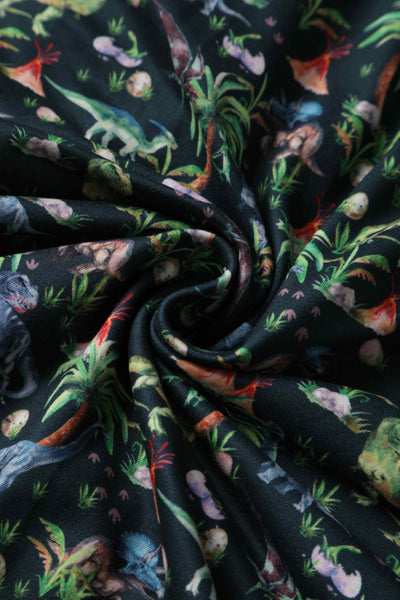 Close up View of Dinosaur and Forest Print Long Sleeved Dress in Green