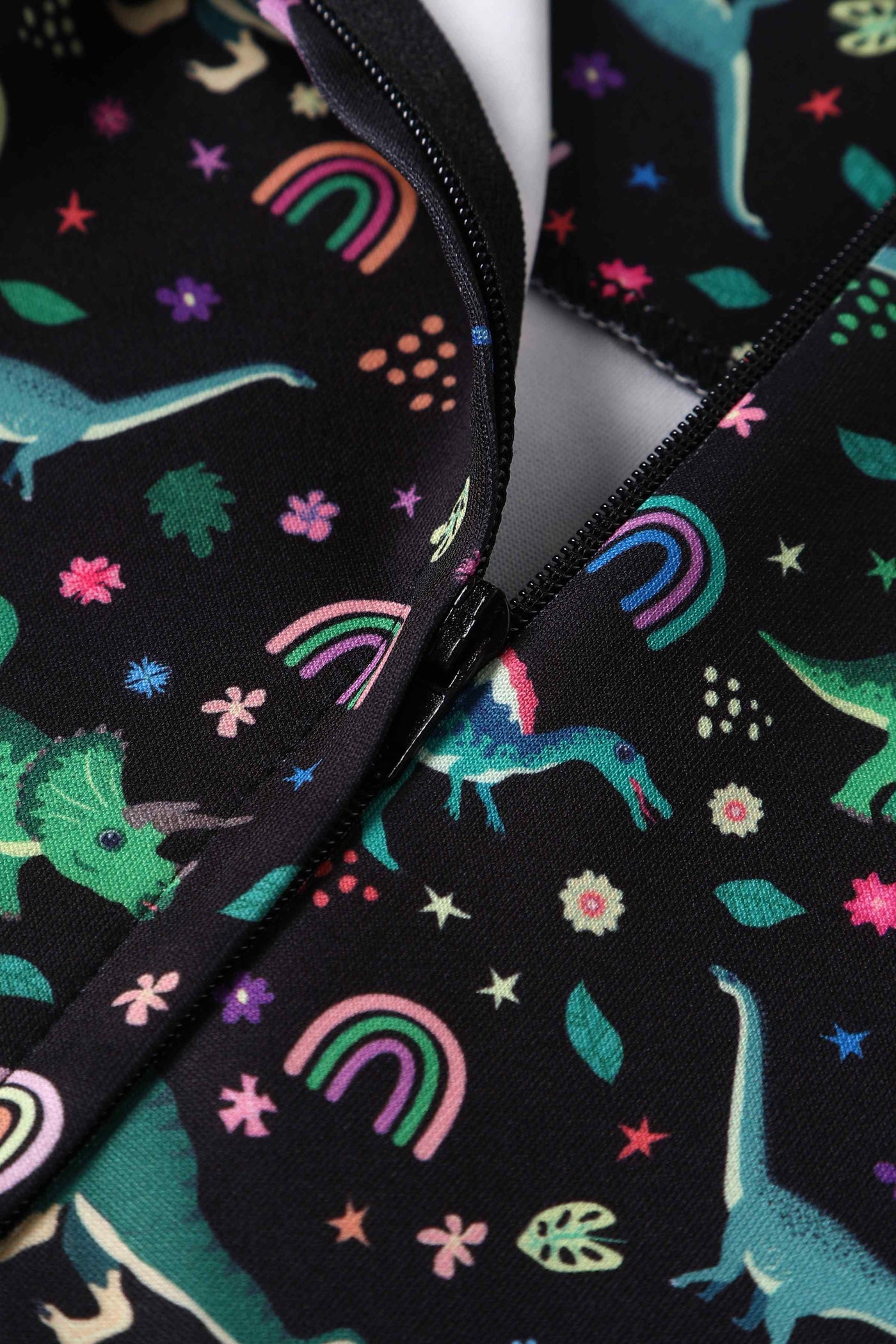 Close up view of Black Flared Dress in Dinosaur & Rainbow Print