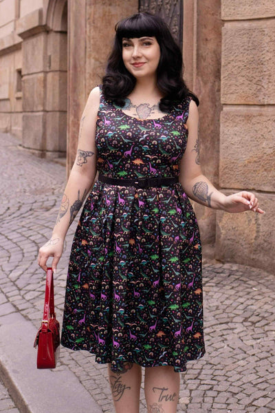 A model wearing a Black Flared Dress in Dinosaur & Rainbow Print