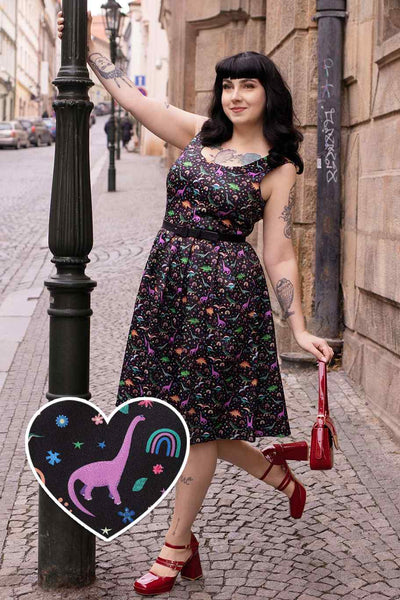 A model wearing a Black Flared Dress in Dinosaur & Rainbow Print