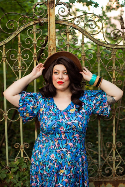 A lady wearing a Dinosaur Navy Blue Petal Sleeve Tea Dress