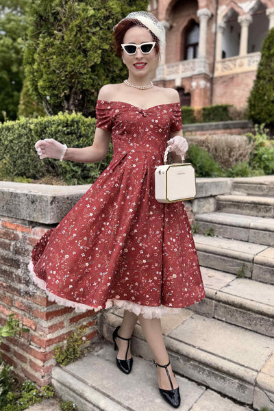 A model wearing Ditsy Floral Off Shoulder Dress In Red