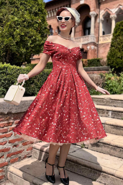 A model wearing Ditsy Floral Off Shoulder Dress In Red