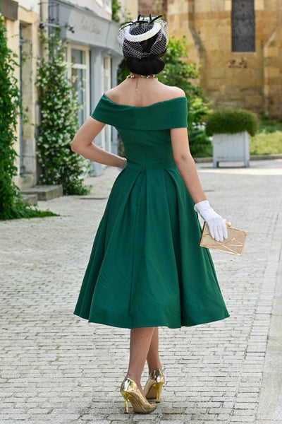 Back view of a woman wearing a Emerald Green Off Shoulder Dress