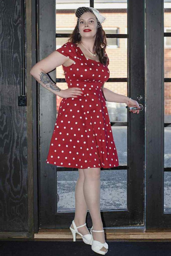 A model wearing a Fifties Style Polka Dot Dress In Burgundy-White