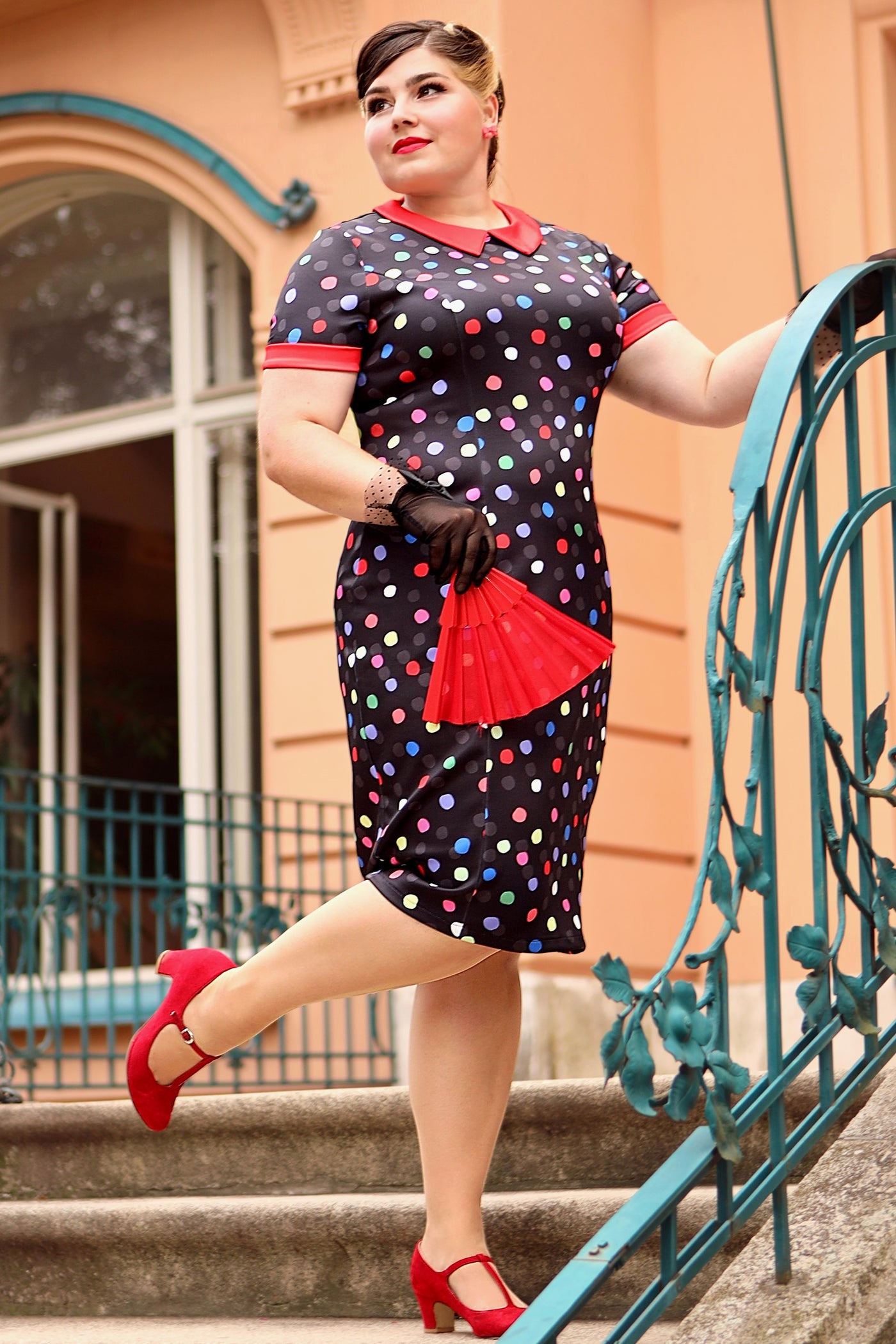 A model wearing a Fitted Collar Dress in Colourful Polka Print