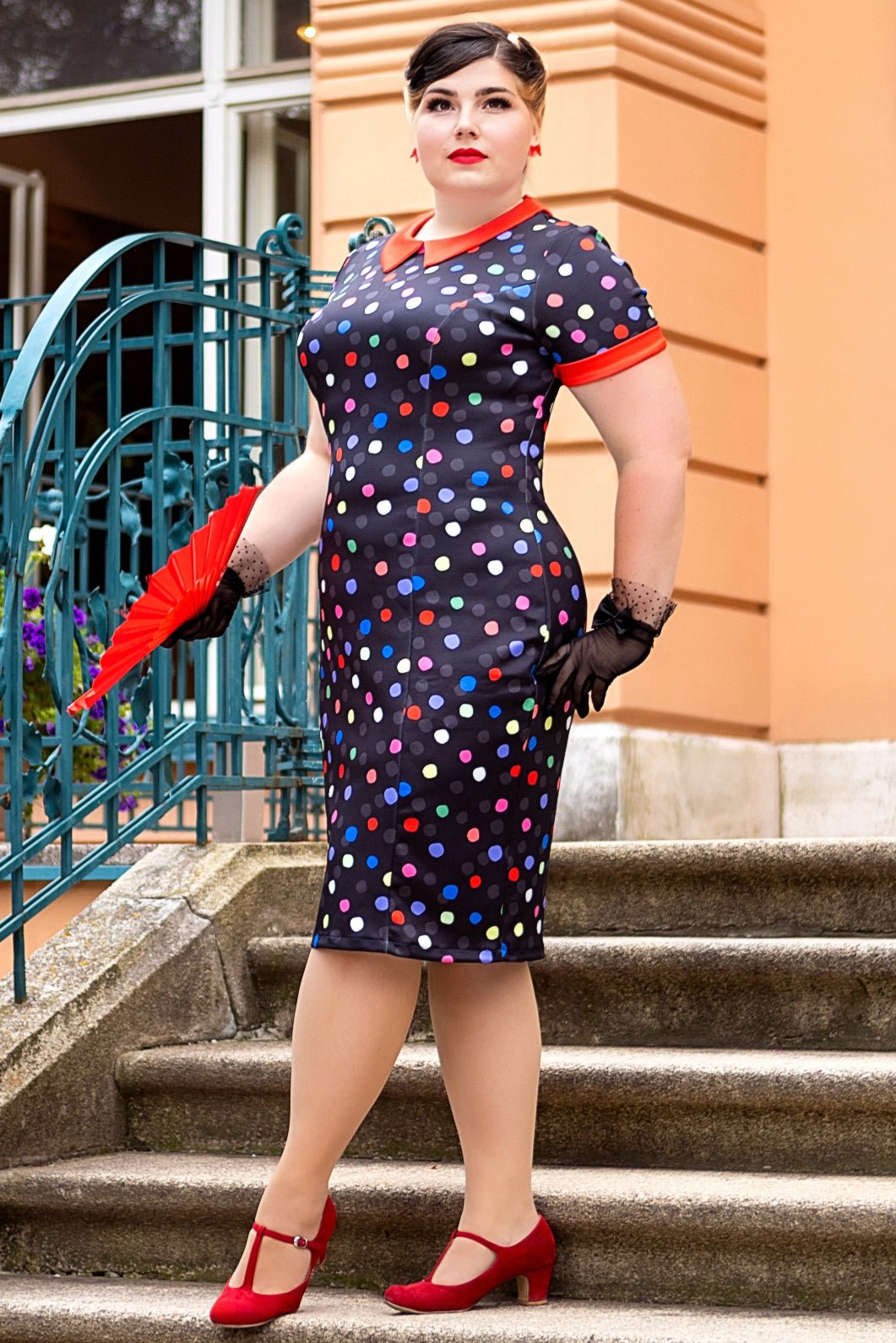 A model wearing a Fitted Collar Dress in Colourful Polka Print