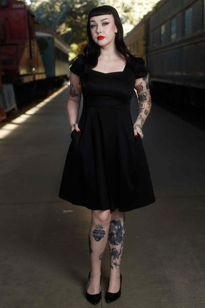 Front view of model wearing Flirty Fifties Style Dress in Plain Black