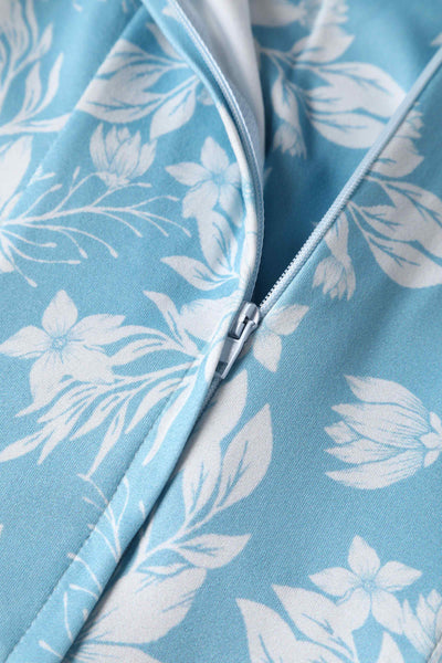 Close up of light blue, with white floral fabric and zip