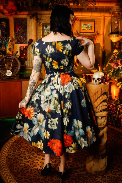 A model wearing a Floral Bunch Off Shoulder Dress In Navy Blue
