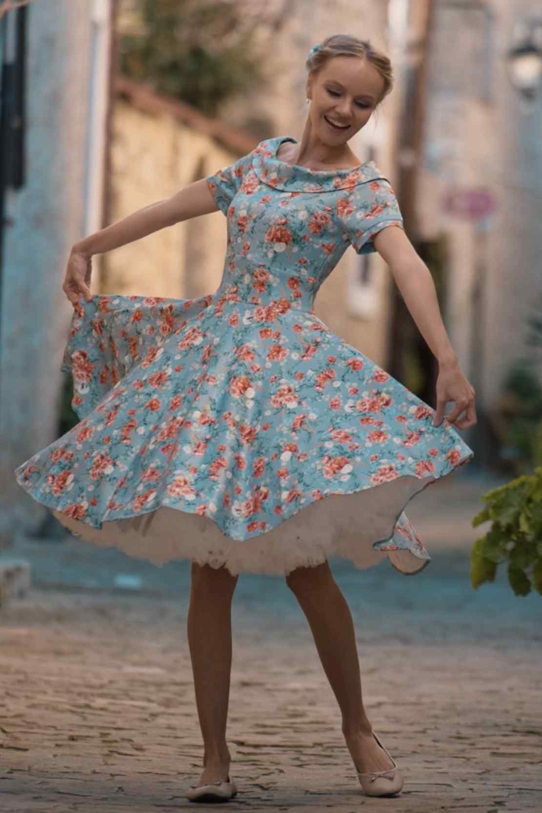 A lady wearing a Blue Floral Off Shoulder Dress