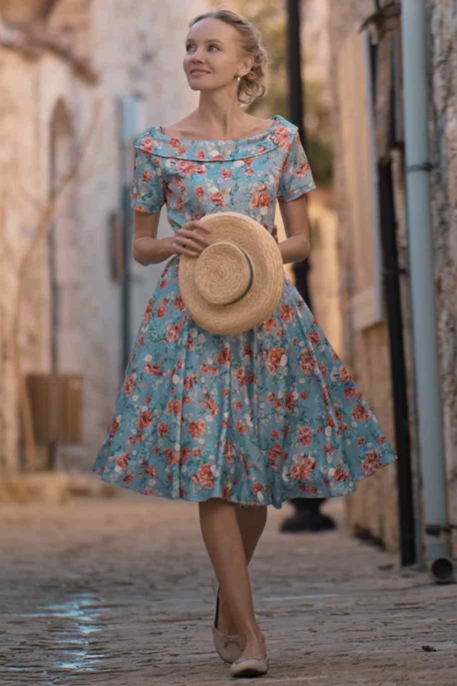 A lady wearing a Blue Floral Off Shoulder Dress