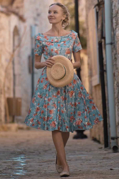 A lady wearing a Blue Floral Off Shoulder Dress