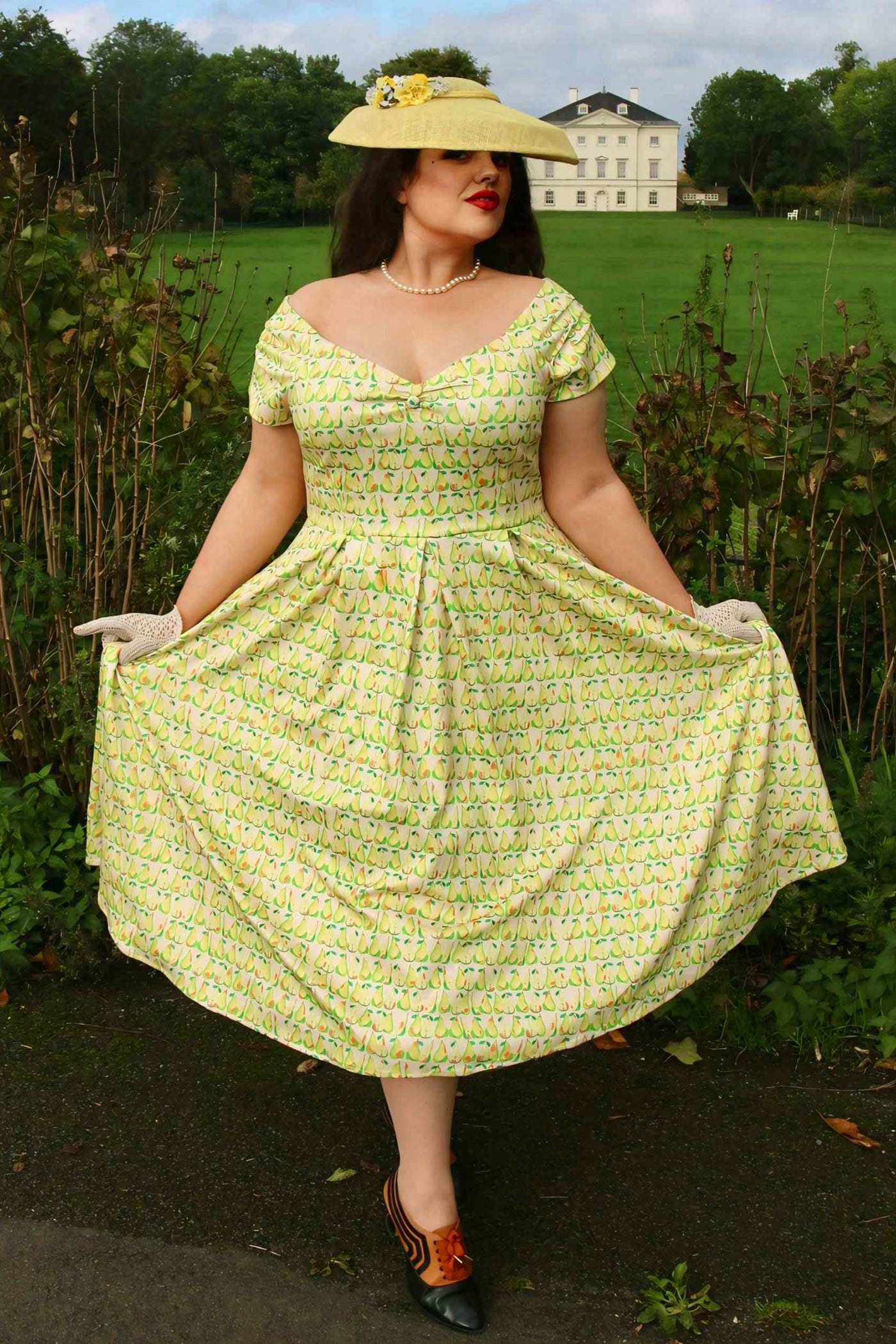 A lady wearing a Fruity Pear Off Shoulder Dress