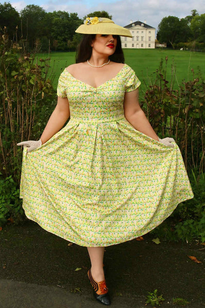A lady wearing a Fruity Pear Off Shoulder Dress