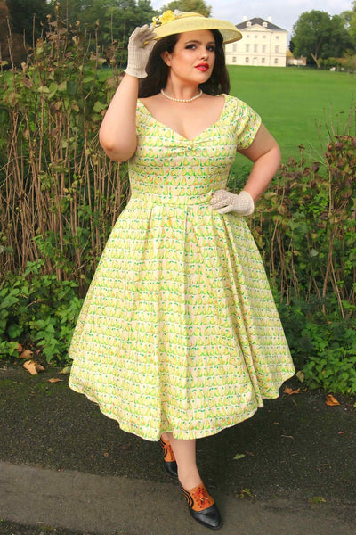 A lady wearing a Fruity Pear Off Shoulder Dress