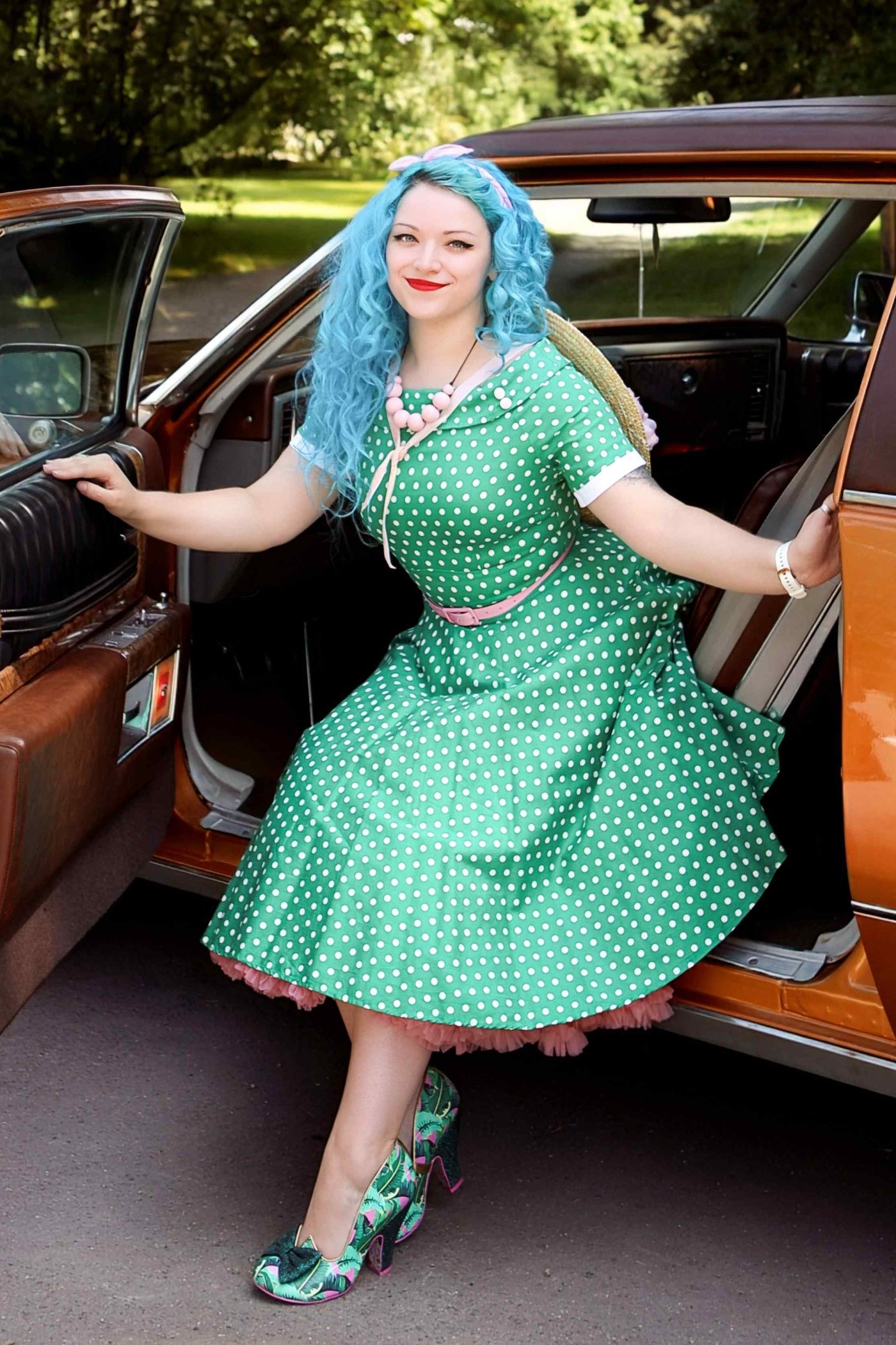 A girl wearing a Full Circle Green Polka Dot Swing Dress