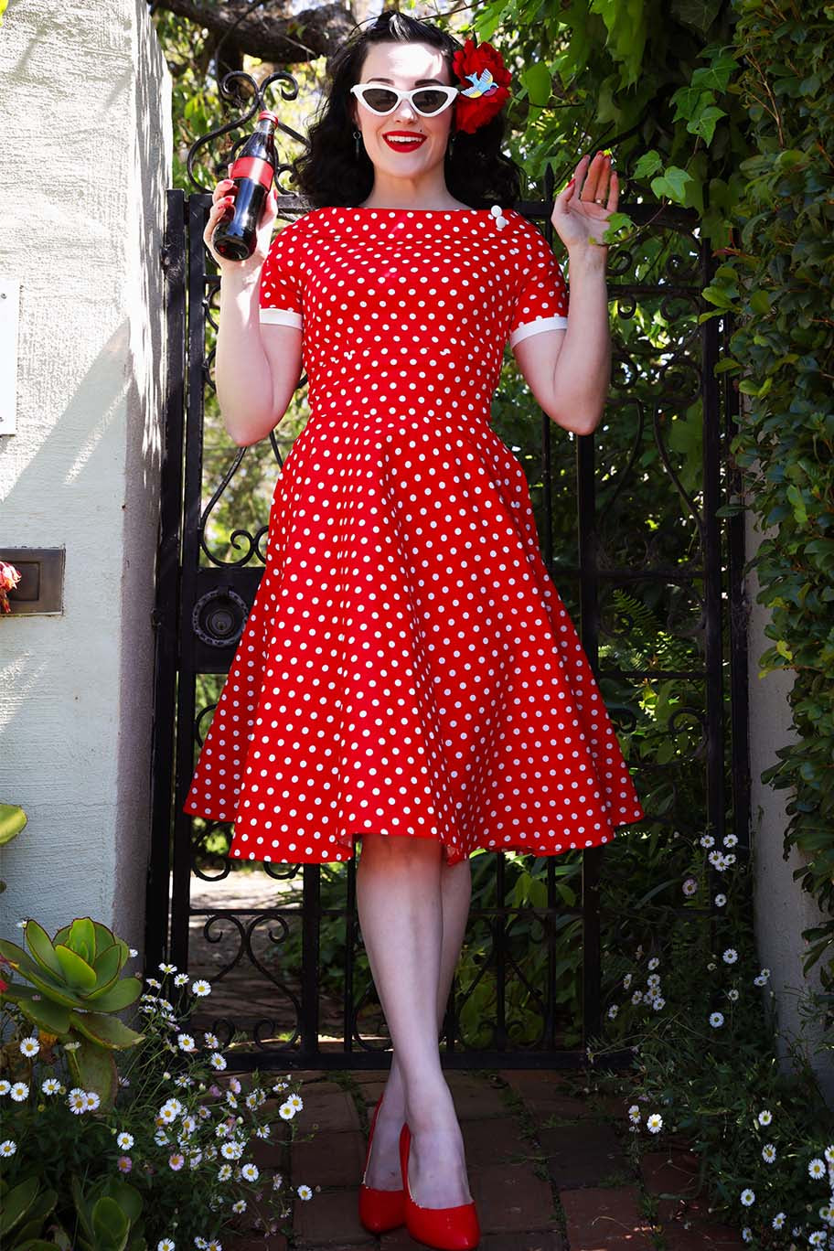 A model wearing a Darlene Full Circle Red Polka Dot Swing Dress