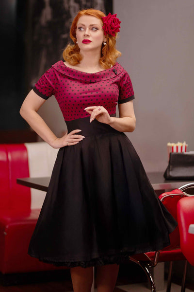 A model wearing a Full Circle Swing Dress in Burgundy Polka-Black